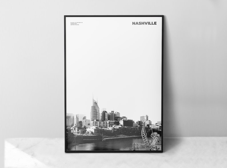 May include: Black and white photograph of the Nashville skyline, featuring the iconic AT&T Building. The image is framed in a black frame and the word "NASHVILLE" is printed in white at the top of the image.