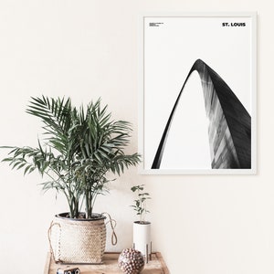 May include: A black and white photograph of the Gateway Arch in St. Louis, Missouri. The arch is a popular tourist destination and a symbol of the city.