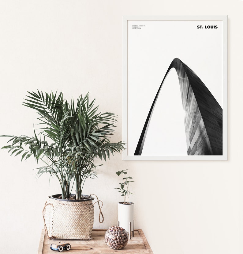 May include: A black and white photograph of the Gateway Arch in St. Louis, Missouri. The arch is a popular tourist destination and a symbol of the city.