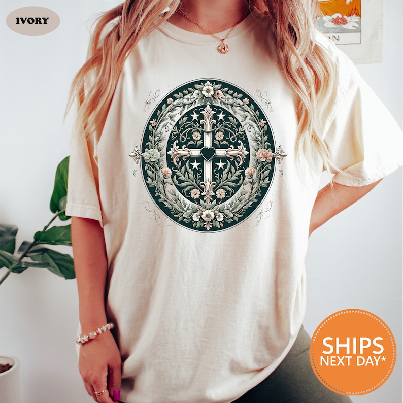 a woman wearing a t - shirt with a cross on it