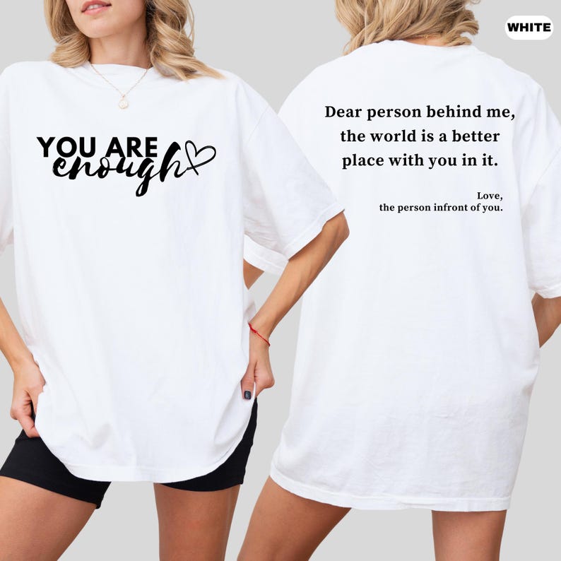 a woman wearing a t - shirt that says you are enough