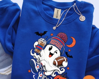 May include: A royal blue crewneck sweatshirt featuring a graphic of a white ghost wearing a blue and red beanie with the text BUFFALO FOOTBALL. The ghost holds a coffee cup and a football, wearing blue trainers, surrounded by bats and a pumpkin.