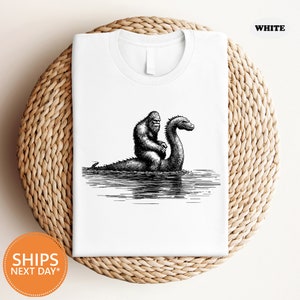 a white t - shirt with a black and white image of a gorilla and a