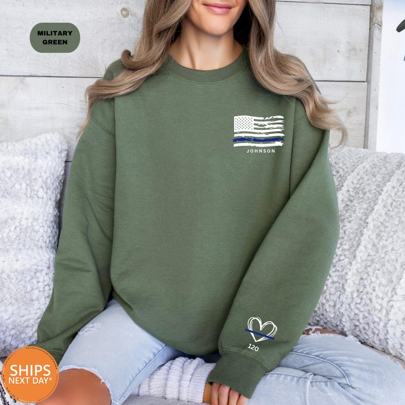 a woman sitting on a couch wearing a green sweatshirt