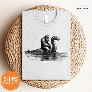 a t - shirt with a picture of a gorilla and a bird on it