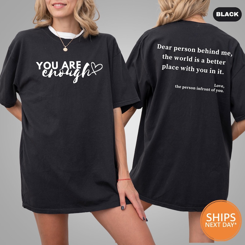 a woman wearing a black shirt that says you are enough