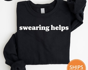 May include: Black sweatshirt with the text "swearing helps" printed in white.