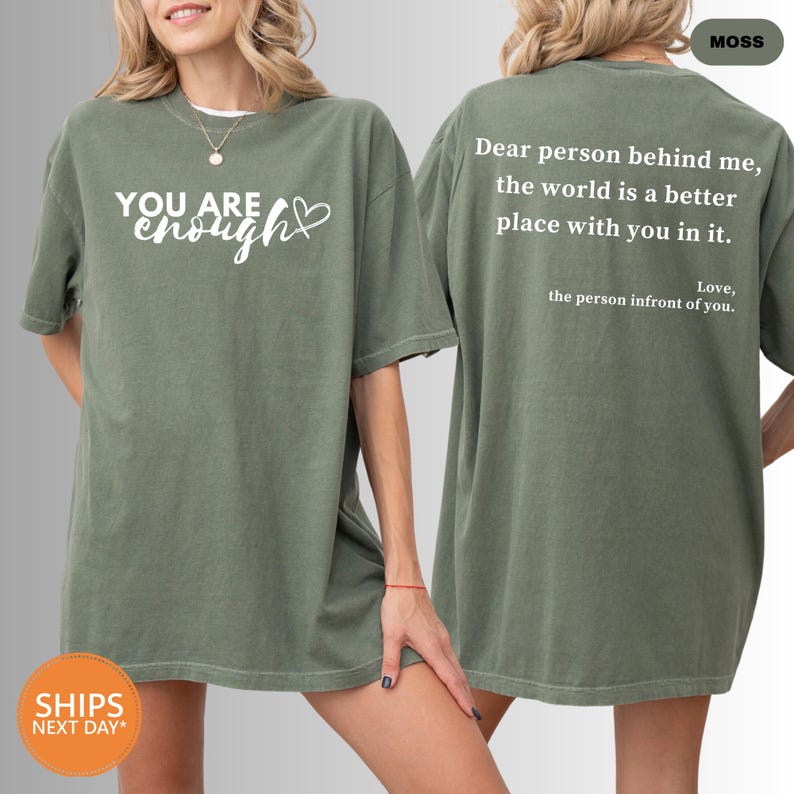 a woman wearing a t - shirt that says you are enough