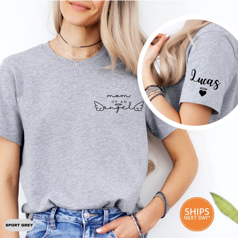 A woman wearing a grey t-shirt with a personalized design, including the text "Mom of an Angel" and a winged symbol.
