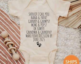 May include: A white baby onesie with black text that reads "Should I call you Nana & Papa? Granny & Gramps? Mimi & Pops? Or simply Grandma & Grandpa? Make your decision by June 2025". There are two small footprints below the text.