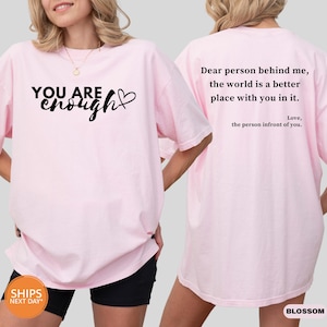 a woman wearing a pink shirt that says, you are beautiful