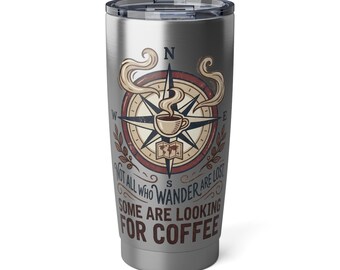 May include: Stainless steel travel mug with a compass design. The design features a coffee cup at the center of the compass, with the text "NOT ALL WHO WANDER ARE LOST SOME ARE LOOKING FOR COFFEE". The mug has a silver finish.
