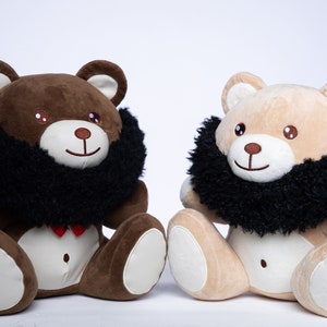 May include: Two plush teddy bears with black furry beards. The bear on the left is brown and the bear on the right is beige.