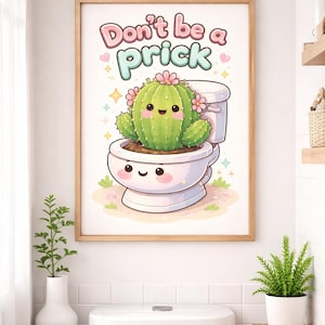 May include: A framed illustration featuring a cartoon cactus with a smiling face, adorned with pink flowers, sitting on a toilet. The text "Don't be a prick" is above the cactus in pink and green letters. The artwork is in a bathroom setting.