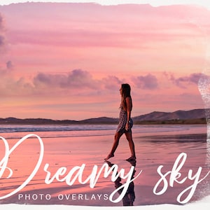 May include: A woman walks along a beach at sunset. The sky is a vibrant pink and orange, with fluffy clouds. The text "Dreamy Sky Photo Overlays" is written in white cursive at the bottom of the image.