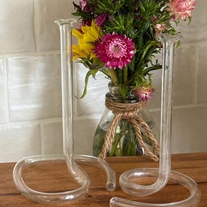 May include: A set of three ceramic mugs with a speckled, matte finish. The mugs are in shades of cream, light gray, and dark gray. Each mug has a simple, minimalist design, perfect for coffee or tea.