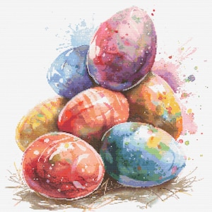 May include: A pile of colourful Easter eggs with watercolour splatters in the background. The eggs are painted in shades of pink, blue, yellow, and red.