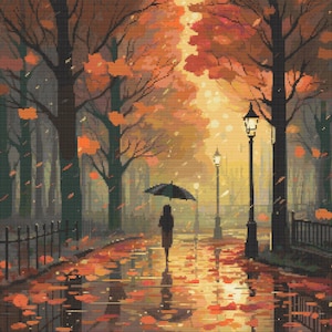 May include: A person walks down a path in a park with a black umbrella. The path is covered in fallen autumn leaves and the trees are bare. The streetlights are on and the sky is a soft orange.