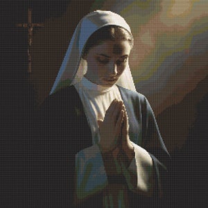 May include: A woman wearing a white habit and a blue robe is praying with her hands clasped together. She is standing in front of a wooden cross.