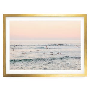 a group of people enjoying themselves in the ocean, with some of them riding waves on surfboards.