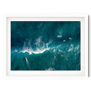 a picture of a group of surfers in the ocean