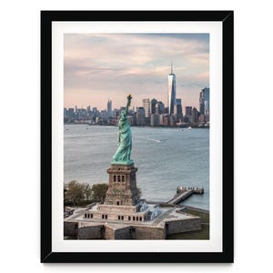 the Statue of Liberty, a famous landmark in New York City, with the city skyline in the background.