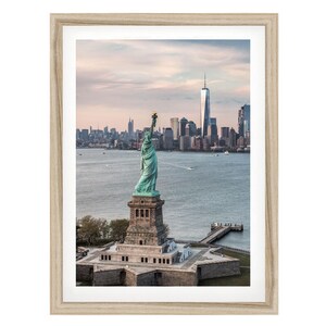 the Statue of Liberty, a famous landmark in New York City, with the city skyline in the background.