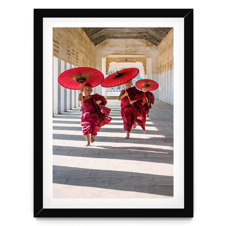 two women with red umbrellas walking down a hallway