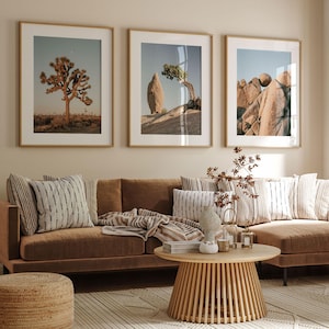 a living room filled with furniture and pictures on the wall