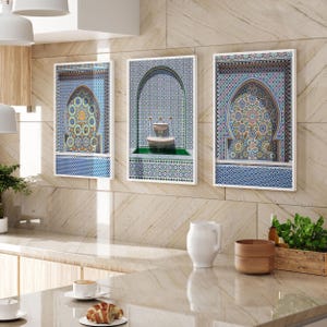 May include: Three rectangular wall art prints featuring intricate blue, white, and gold geometric tile patterns. The two outer prints display arched alcoves with complex star motifs, while the center print depicts a tiered stone fountain.