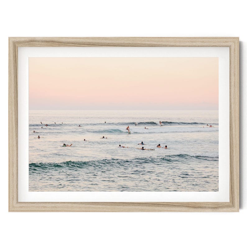 a group of people enjoying themselves in the ocean, with some of them riding waves on surfboards.