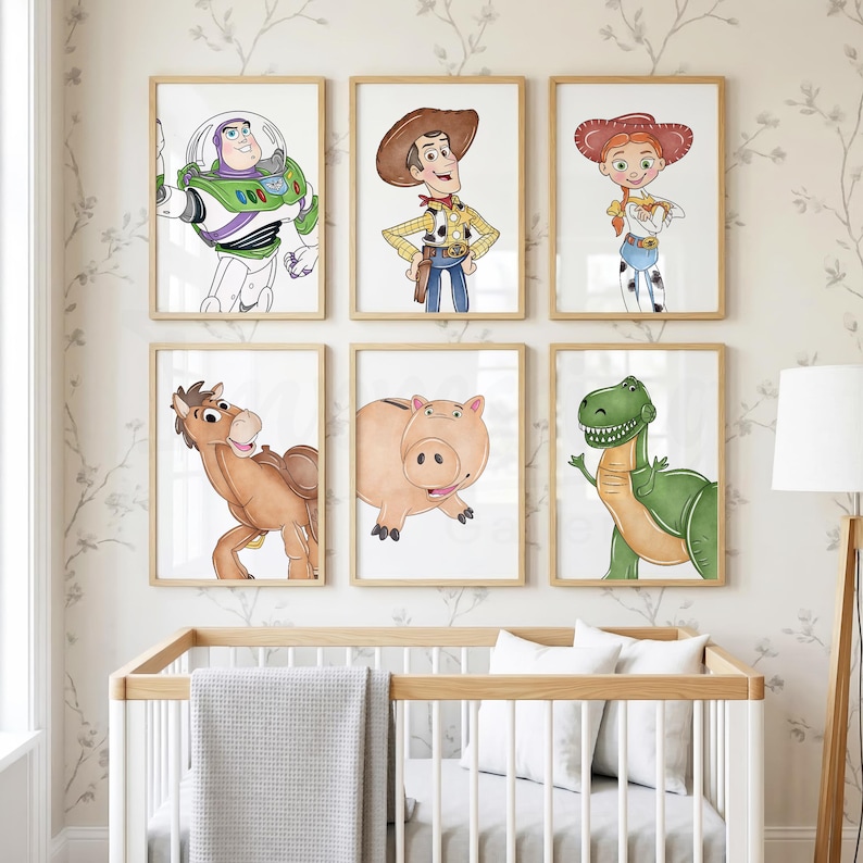 May include: Six framed watercolor prints featuring characters from the animated film Toy Story. The characters include Buzz Lightyear, Woody, Jessie, Bullseye, Hamm, and Rex. The prints are displayed above a white crib with a gray blanket.