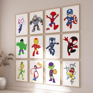 May include: A set of framed superhero art prints. The prints showcase colourful illustrations of comic book characters such as Spider-Man, Captain America, and Iron Man. The artwork is displayed on a light-coloured wall.