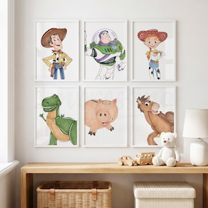May include: Six framed art prints featuring characters from a popular animated film. The prints include a cowboy, a space ranger, a cowgirl, a green dinosaur, a pink pig, and a brown horse. The artwork is in a watercolor style.