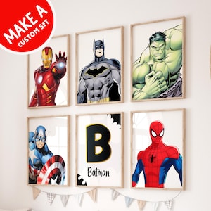 May include: A set of six framed prints featuring superhero characters. The prints include Iron Man, Batman, Hulk, Captain America, Spiderman, and a letter B with the word "Batman" underneath.