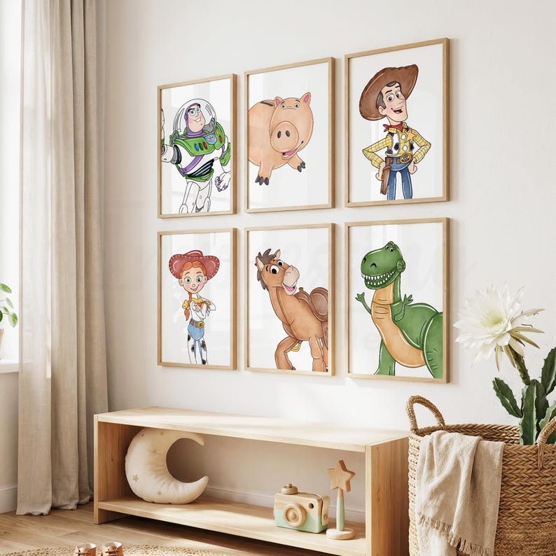 May include: Six framed watercolor prints featuring characters from the animated film Toy Story. The prints include Buzz Lightyear, Hamm the pig, Woody, Jessie, Bullseye, and Rex the dinosaur. The frames are a light brown color and are mounted on a white wall.