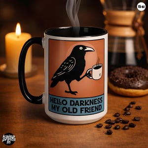 May include: A white 425ml coffee mug with a black handle and interior. The mug features a black crow illustration holding a coffee cup, with the text "Hello Darkness My Old Friend" on a blue banner. Steam rises from the mug. Coffee beans and a donut are in the background.