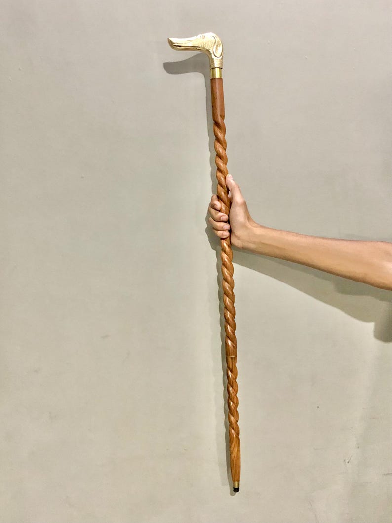 May include: A wooden walking stick with a twisted design and a brass dog head handle.