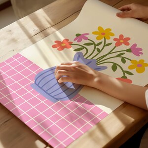 May include: A colorful floral print with a bouquet of flowers in a blue vase on a pink and white checkered background.