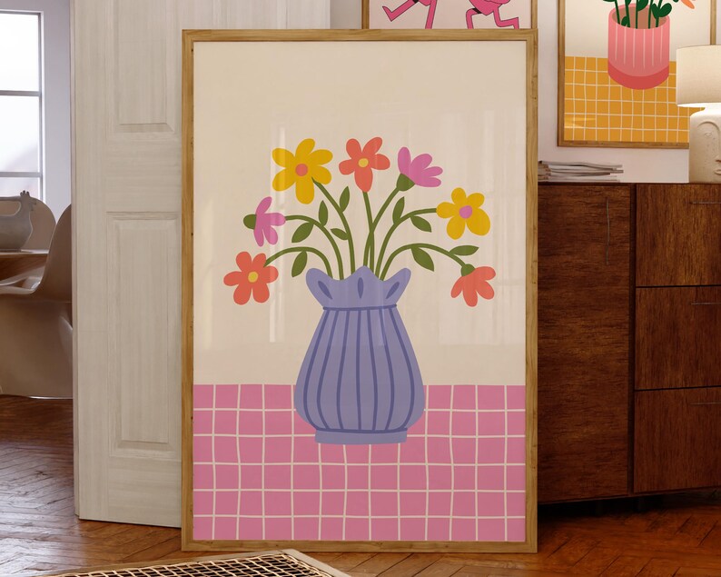 May include: A colorful floral arrangement in a blue vase with a pink and white checkered background. The flowers are yellow, pink, orange, and red.
