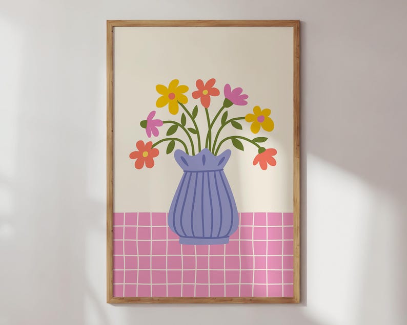 May include: A framed print of a blue vase with a bouquet of colorful flowers on a pink and white checkered background.