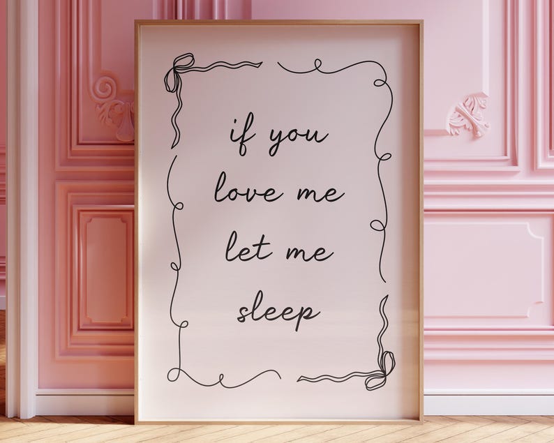 May include: A framed print with a white background and black text that reads "if you love me let me sleep". The text is surrounded by a decorative black border.