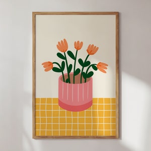 May include: A framed illustration of a potted plant with orange flowers and green leaves on a yellow checkered background.