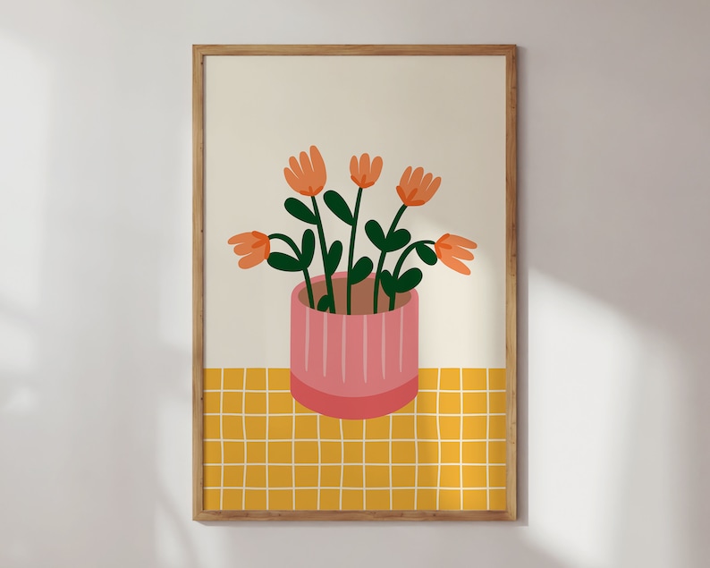 May include: A framed illustration of a potted plant with orange flowers and green leaves on a yellow checkered background.