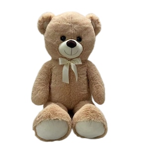Pode incluir: Um grande urso de pelúcia, sentado. O urso é castanho claro com um laço branco e almofadas brancas. Tem um rosto sorridente com um nariz preto e olhos escuros. É um brinquedo clássico.