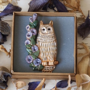 Owl brooch pin. Ceramic eagle owl sits on a branch with blue flowers. Pottery brooch eagle-owl. image 1