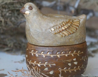 Tea jar bird in the nest. Ceramic jar for coffee and spices. Ceramic box chicken