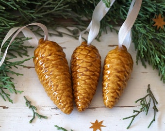 Set of three ceramic pine cones for Christmas tree decoration. Christmas tree ornament. Interior decoration. Christmas toys