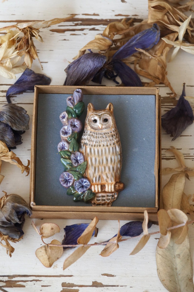 Owl brooch pin. Ceramic eagle owl sits on a branch with blue flowers. Pottery brooch eagle-owl. image 1