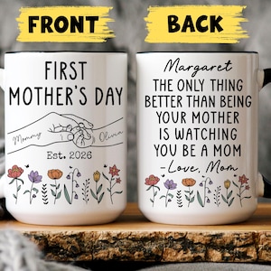 May include: White ceramic mug with black handle and rim, featuring text "FIRST MOTHER'S DAY" and "Est. 2026". The back of the mug says "Margaret, the only thing better than being your mother is watching you be a mom". Floral design at the bottom.
